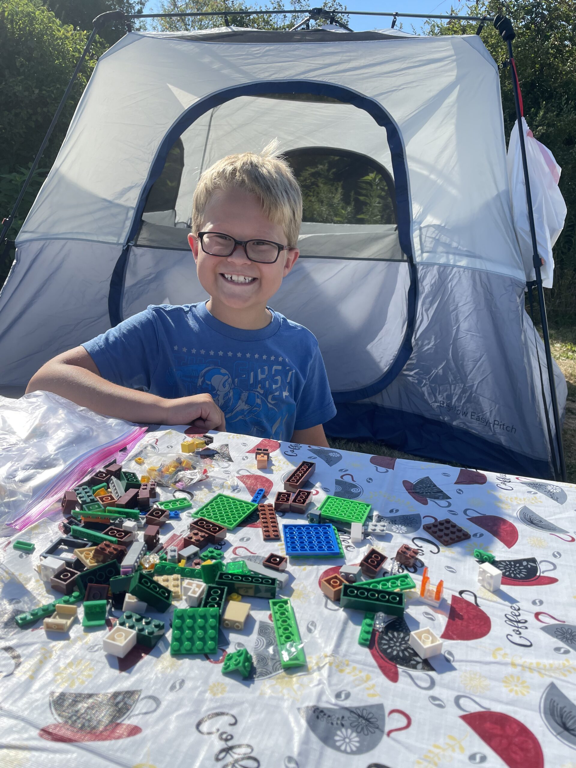 camping with kids and babies, little boy playing at the campsite with lego's.